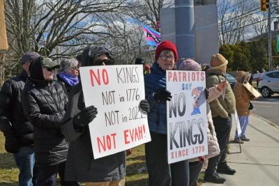 Two signs saying that America hasn't had kings since 1776.