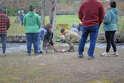 Josephine Runey (7,) Shane Runey (6,) and Caleb Reutzel (6) investigate some of the duckies. 