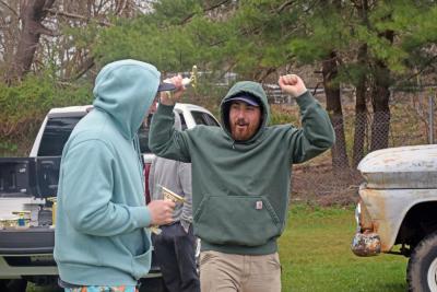 Two racers celebrate with their trophies. 