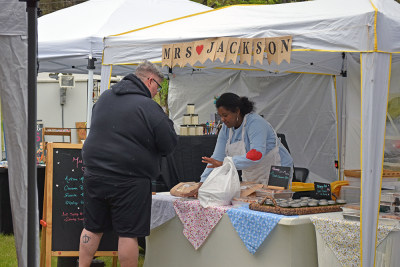 A baker talks to a customer about her baked goods. 