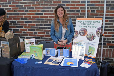 Rachel manning a booth about supporting children in activities.