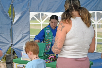 Nora Hecht explains their water safety stations at the Lakeville plant sale. 