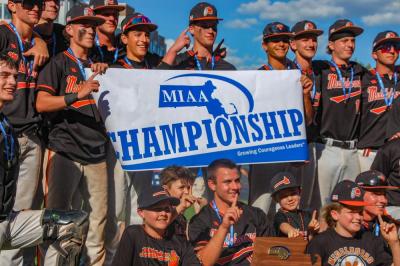 This year's Division 3 champions hold up their trophy and a banner after their win. 