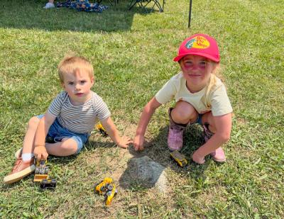 Colton Westgate, 18 months, and Adeline Burns, 5, play on the farm grounds. Photos by Sandy Quadros Bowles 