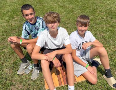 Friends, from left, Andrew Cabral, Nate Wronski and Chase Lynch, all 13, chill out in the sun. 