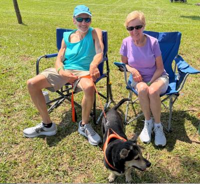 John Raymond, Jeannie Kruja and Toby the dog take in the tunes.