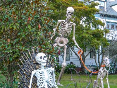 A skeleton watches over S Main St. from his throne, while another peers over its shoulder with its dog. Photo by Christian Uva