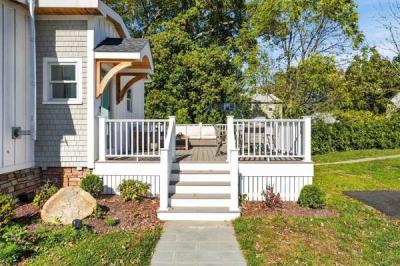 Stone walkway and white railed steps leading up to the deck at 226 Sanford Road in Westport, MA