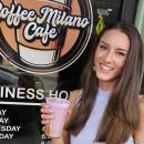 Hope Anderson stands outside Coffee Milano Cafe holding a purple cold brew. Photo source: Lorna Brunelle Hope Anderson stands outside Coffee Milano Cafe holding a purple cold brew.