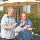 Leilani Dalpe (right) announces the winners of the baking contest. 