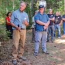 Foresters Phil Benjamin (left) and Tom Farrell guide a tour group at the Frederick Weston Memorial Forest.