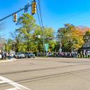 A line of protesters crowd the sidewalks at the junction of Routes 105 and 28. 