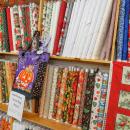 Seasonal fabrics cover a shelf of the store. 