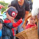 Two boys dressed as Spider-Man pick candy from a basket at Ted Williams Camp during the trunk or treat Oct. 19. 