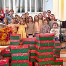 Volunteers stand with the gift boxes they packed at Central Congressional Church. Photo source: Central Congressional Church