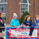Middleboro Girl Scouts hold their sign during the parade. Photo by Grace Roche