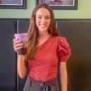 Hope Anderson poses at Coffee Milano with her purple drink for Prematurity Awareness Month. Photo by Grace Roche