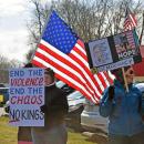 Protesters with the American flag behind them.
