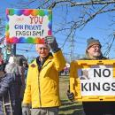 Two protesters ask for no kings and no fascism. 