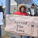 A woman's sign calls for love.