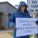 A man shows off his sign.