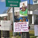 Signs calling for democracy over kings.