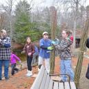The girl scouts help pass the whips down to the volunteers.