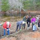 All of the volunteers work together to weave the whips onto the poles. Photos by Kat Sheridan