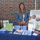 Rachel manning a booth about supporting children in activities.