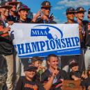 This year's Division 3 champions hold up their trophy and a banner after their win. 