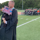 Middleboro High School Assistant Principal Andrew Dizel hugs a student at a previous graduation. File photo