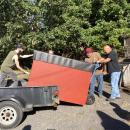Cash gets help from some friends to replace the donation bin. 