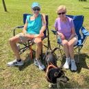 John Raymond, Jeannie Kruja and Toby the dog take in the tunes.