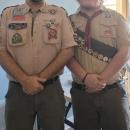 Troop leader Kevin Thompson stands with Cash. 