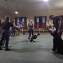 Dog trainer Sherri Swindle instructs Sherry Cowan, of Middleboro, in leading her dog, Theo, in a “figure eight” path. She acts as a “post” with Bill McDermott, from Middleboro, and dog Bear to create a reference for the path.