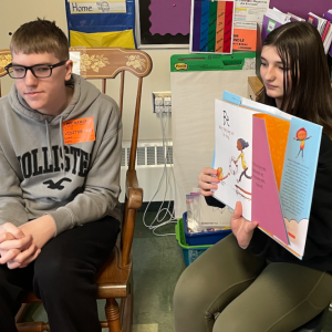 Justin Dahlgren and Stephenie Kent read to the children.