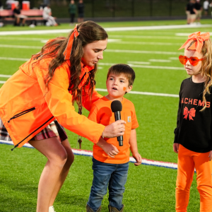 From Left: Kindergarten teacher Carly Paling and students Collin Bertram and Willow Norvish speak during the Middleboro meet at the 50 event. 