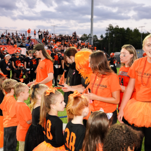 Senior and kindergarden students meet in the middle of the Middleboro High School football field Sept 19. 