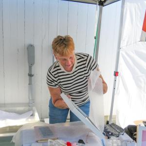 Vendor Sheryl LeBlanc wraps up a piece of art at the festival. 