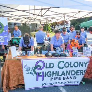 Performers from the Old Colony Highlanders pipe band at their tent. 