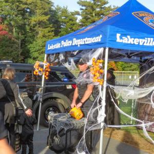 Lakeville Police officer Adam Swift hands out candy at the trunk or treat event. 