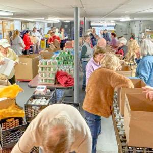 Volunteers at the Sacred Heart Food Pantry help make Thanksgiving food baskets. Photos source: Ellen Burke