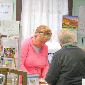One of the longtime volunteers at Nearly New Thrift Store rings up a customer on Nov. 20. Photos by Grace Roche