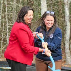 Driscoll (left) and Select Board member Teresa Farley break ground on the project together. 