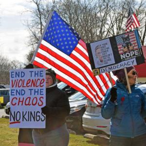 Protesters with the American flag behind them.