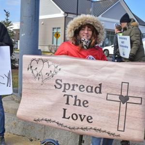 A woman's sign calls for love.