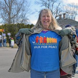 A woman shows off her shirt.