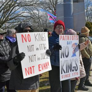 Two signs saying that America hasn't had kings since 1776.
