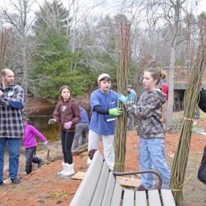 The girl scouts help pass the whips down to the volunteers.