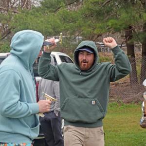 Two racers celebrate with their trophies. 